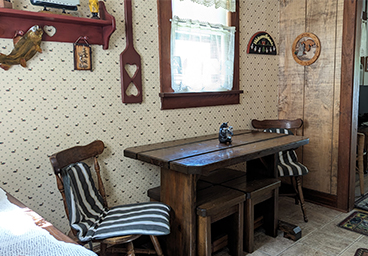 looking into the dining room from the kitchen at Cedar Cliff Cottage - dining room table with seating for four