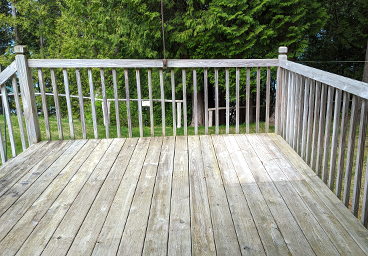 looking out onto the deck from the living room's sliding glass door at Cedar Cliff Cottage