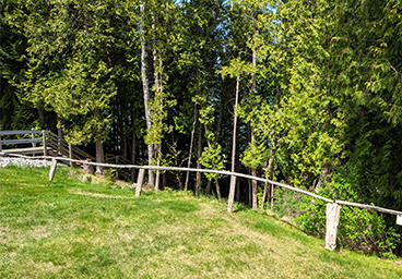 following the guardrail to the stairs leading to the beach at Cedar Cliff Cottage